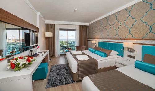a hotel room with two beds and a couch at Luna Blanca Resort & Spa in Side
