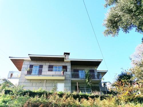 a building with blue windows on the side of it at Refúgio do Seixoso in Celorico de Basto
