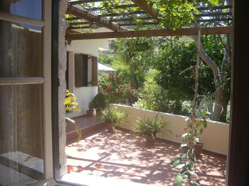 a view of a patio with potted plants at Hariklia Rent Rooms in Zarós