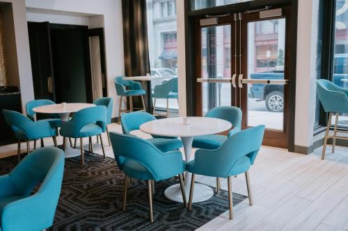a row of tables and chairs in a restaurant at Hotel Indigo - St. Louis - Downtown, an IHG Hotel in Saint Louis