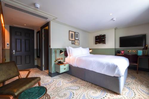 a bedroom with a large bed and a living room at Home Grown - Private Member's Club in London