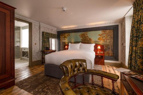 a hotel room with a bed and a chair at Home Grown - Private Member's Club in London