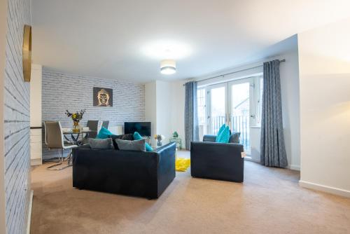 a living room with two couches and a table at No4 Nursery Convent in Mansfield