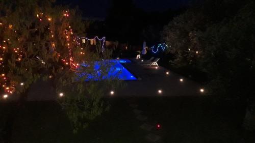 an overhead view of a yard at night with christmas lights at MEDITERRANEAN GARDEN VILLA in Vathí