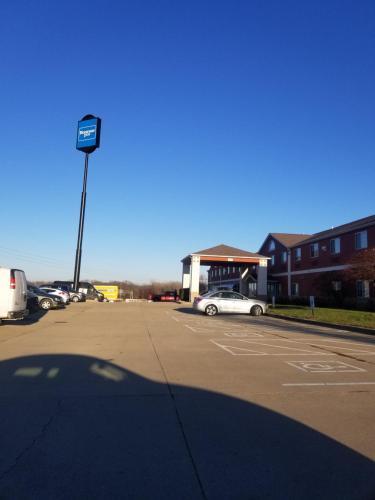 a parking lot with a car parked in front of a building at Rodeway Inn Urbana Champaign University Area in Champaign