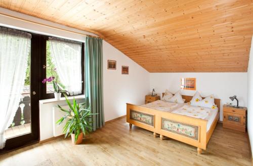 a bedroom with a bed and a large window at Ferienwohnung Daiber in Bernau am Chiemsee