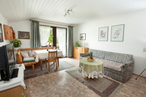 a living room with a couch and a table at Ferienwohnung Daiber in Bernau am Chiemsee