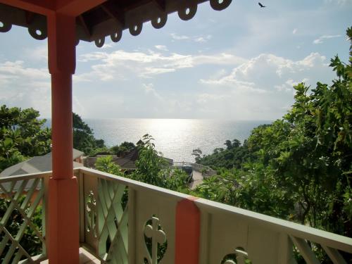 a view of the ocean from the balcony of a house at Pimento Lodge Resort in Port Antonio