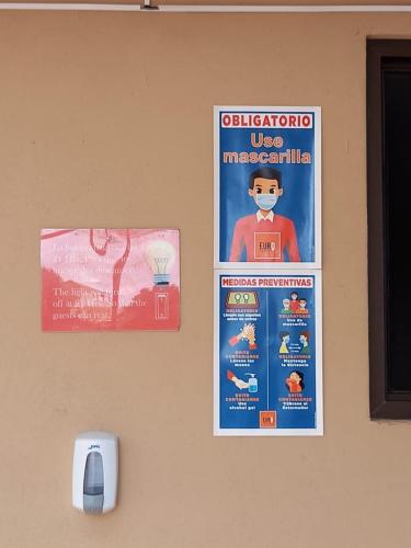 a poster on a wall with a lego man with a face mask at Euro Hostal in Guatemala