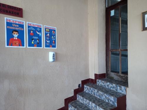 a staircase with posters on the side of a building at Euro Hostal in Guatemala