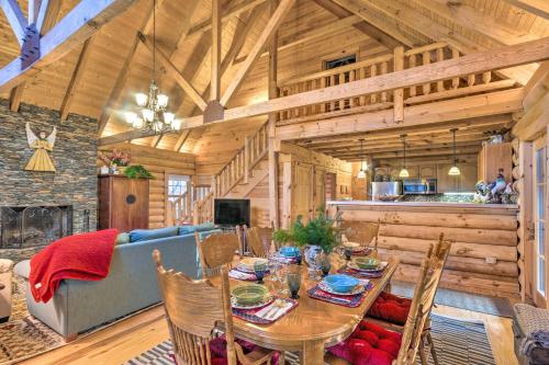 a dining room with a table and a couch at Superb Linville Mountain Cabin with Wraparound Decks in Linville