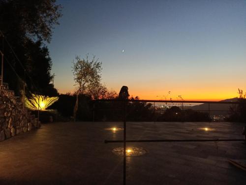 a person sitting on a fence watching the sunset at la gatta sul sentiero in San Salvatore