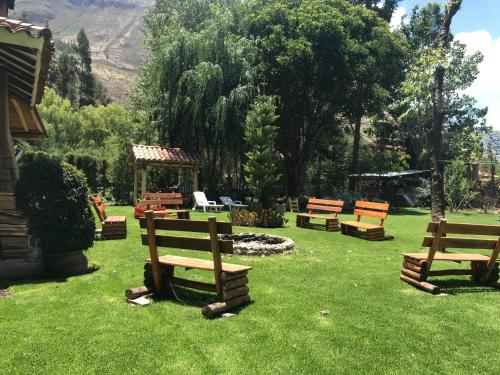 a group of benches sitting in the grass at Karina Wasi in Pisac