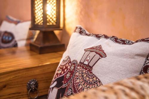 a bed with a pillow with a hand painted on it at 三星宿x包棟民宿 享有專屬空間 in Sanxing