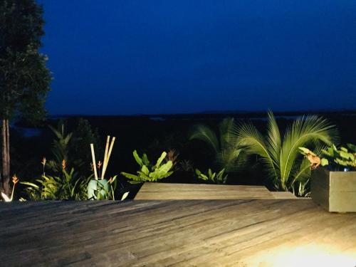 a wooden deck at night with the ocean in the background at Villa F&B in Bocas del Toro