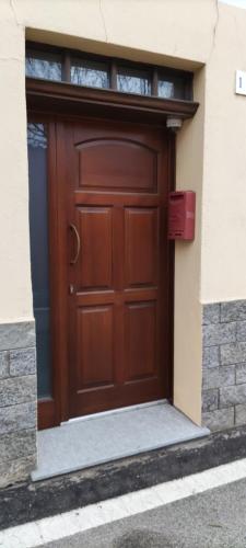 a brown door on the side of a building at La Nina in Sangano