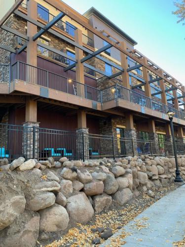 a building with a stone wall in front of a building at Holiday Inn Express Durango Downtown- Animas River in Durango