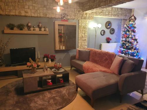 a living room with a christmas tree and a couch at In The Castle - House in Ioannina