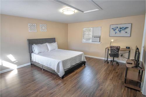 a bedroom with a bed and a desk in it at Houston St Guest house near Downtown/Military base in San Antonio