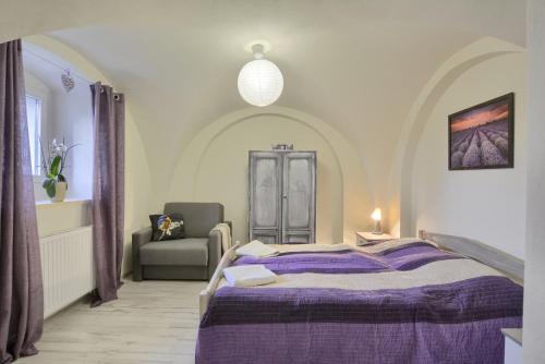 a bedroom with a bed and a chair in it at Siedlisko Krasna in Świeradów-Zdrój