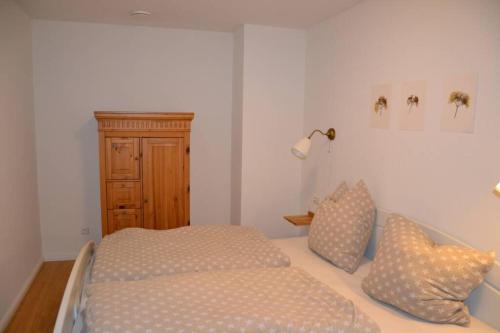 a bedroom with a bed and two pillows on it at Ferienwohnung Boger in Wannweil