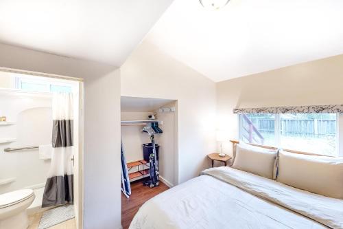 a white bedroom with a bed and a window at The Craftsman House in Springfield