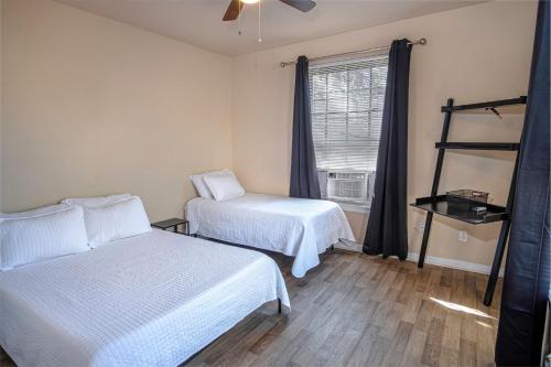 a bedroom with two beds and a window at Nice 3B 2BA Near Downtown 2 Min AtandT Center in San Antonio
