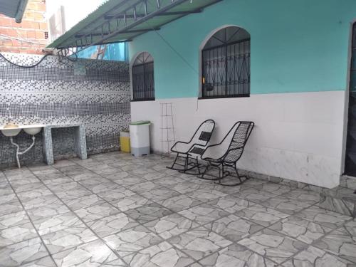 two chairs sitting on the patio of a building at Casa De férias in Manaus