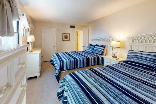 Een bed of bedden in een kamer bij 101 - Sandy Shores