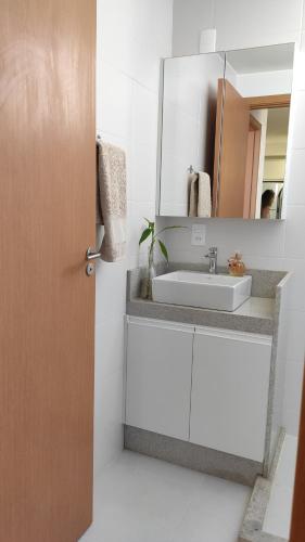 a bathroom with a sink and a mirror at Paraíso Frente ao Mar in Barra Velha
