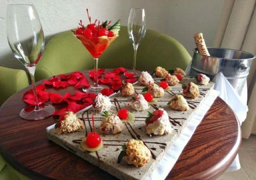 a table with a tray of food and wine glasses at Hotel Las Puertas de Tepoztlan in Tepoztlán