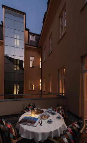 a table with plates of food on top of a building at Unesco Prague Apartments in Prague