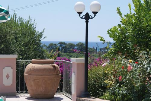 a street light with a large vase next to a fence at Hotel Ristorante Borgo La Tana in Maratea