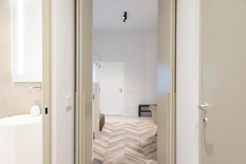 a room with white walls and a wooden floor at Cattolica Apartments in Cattolica