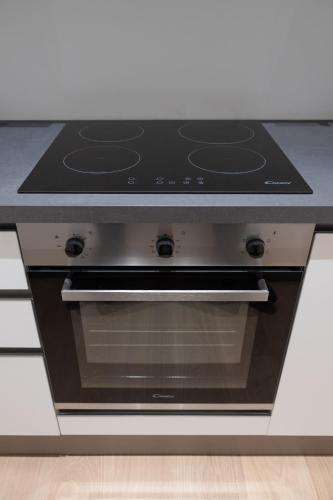 a stove top oven sitting inside of a kitchen at Cattolica Apartments in Cattolica