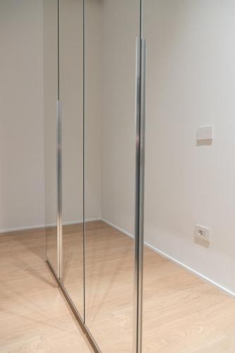 a pair of glass doors in a room with a wooden floor at Cattolica Apartments in Cattolica