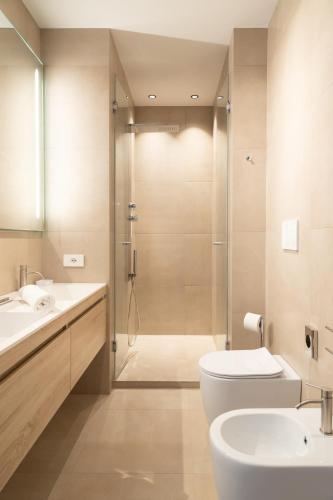 a bathroom with a shower and a toilet and a sink at Cattolica Apartments in Cattolica