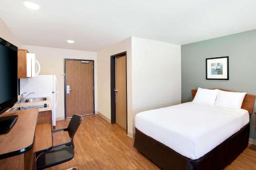 a hotel room with a bed and a desk at WoodSpring Suites Lake Charles in Lake Charles