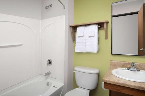 a bathroom with a white toilet and a sink at WoodSpring Suites Murfreesboro in Murfreesboro