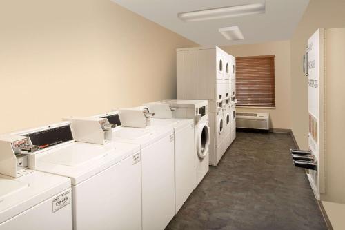 a laundry room with white washers and dryers at WoodSpring Suites Greenville Simpsonville in Simpsonville