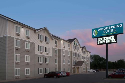 a building with a street sign in a parking lot at WoodSpring Suites Killeen in Killeen