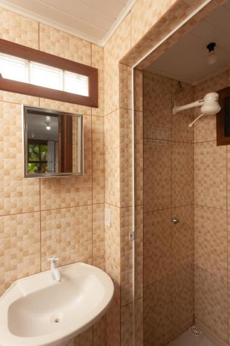 a bathroom with a sink and a shower at Recanto do Sossego in Garopaba