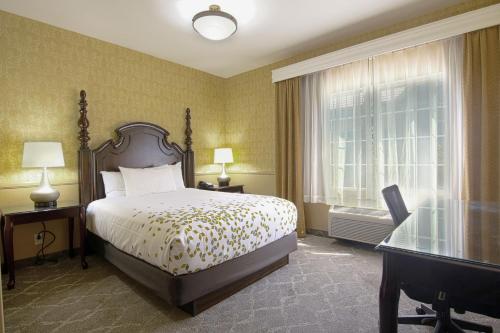 a hotel room with a bed and a window at Azure Hotel&Suites Ontario Trademark Collection by Wyndham in Ontario