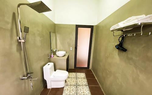 a bathroom with a toilet and a sink at Karst Villas Phong Nha in Phong Nha