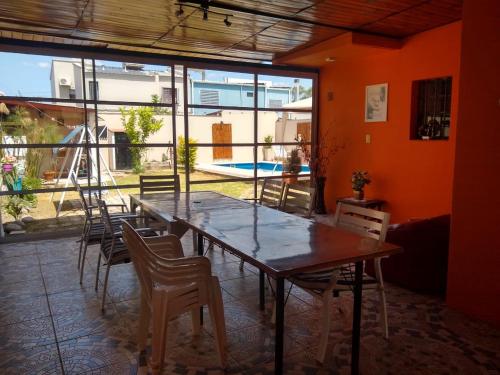 a dining room with a wooden table and chairs at Casa de Vacaciones ADELITA in Establecimiento Las Costas