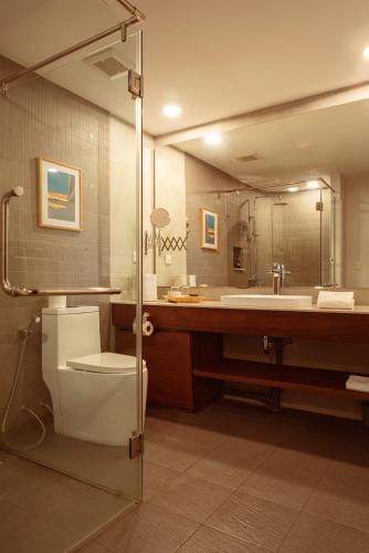 a bathroom with a toilet and a sink at Penh House Hotel in Phnom Penh