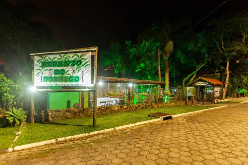 a sign on the side of a street at night at Recanto do Sossego in Garopaba