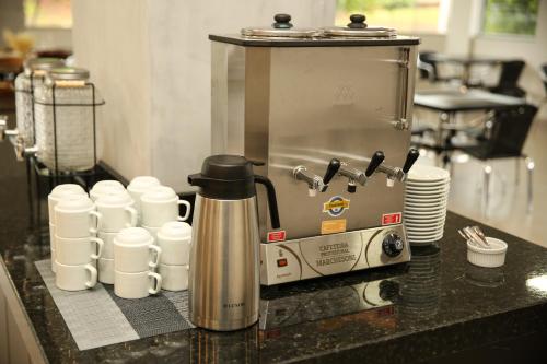a coffee maker on a counter in a kitchen at Raf Hotel in Umuarama