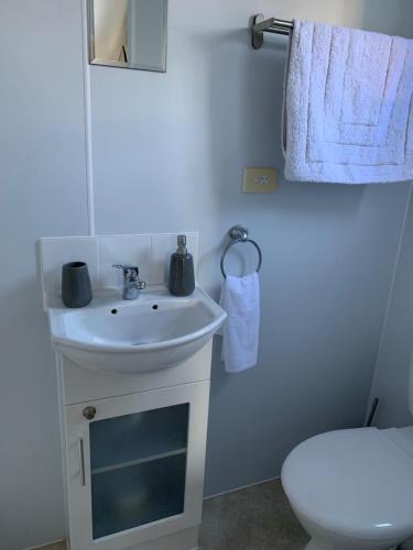 a bathroom with a white sink and a toilet at Wine Country Tourist Park Hunter Valley in Nulkaba