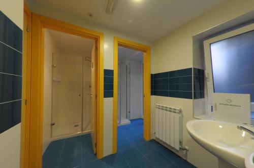 a bathroom with a sink and a mirror at Pensión la Marinera in San Sebastián